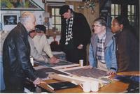 Group discussing maps on SITW studio table