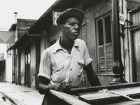 Percy Randolph standing outside his home