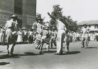 Men and children of the George Williams Brass Band dancing during the YMOBA Jr. Division parade