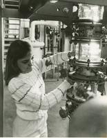 Woman workingin with machinery 